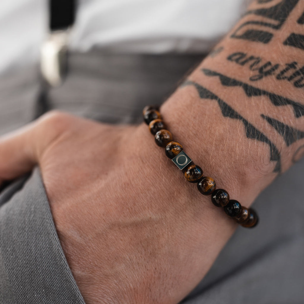 A man wearing a beaded bracelet.
