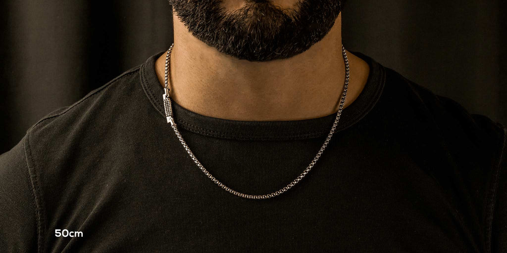 A man wearing a chain necklace.
