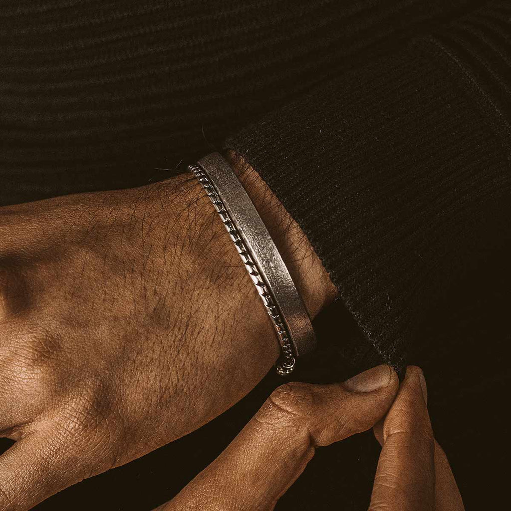 A man is wearing a bracelet.