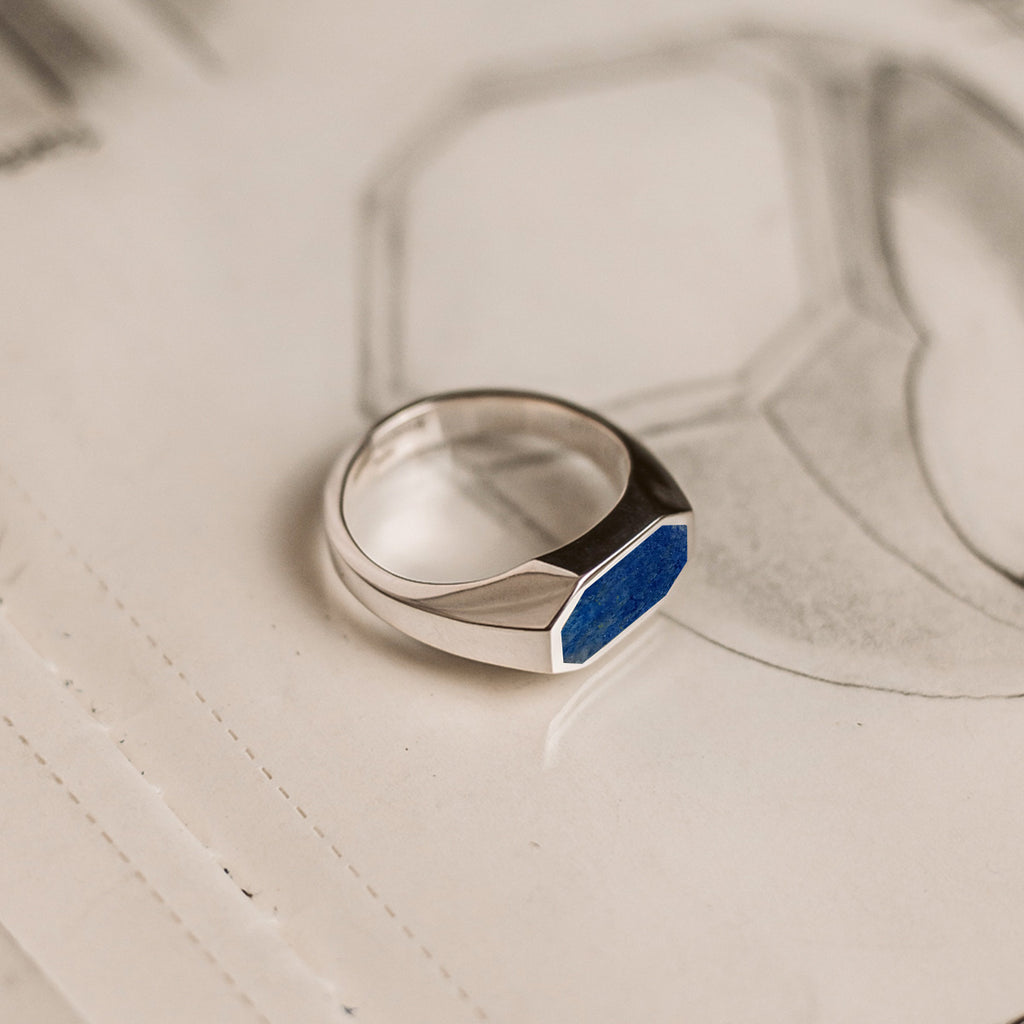 A silver ring with a blue stone.