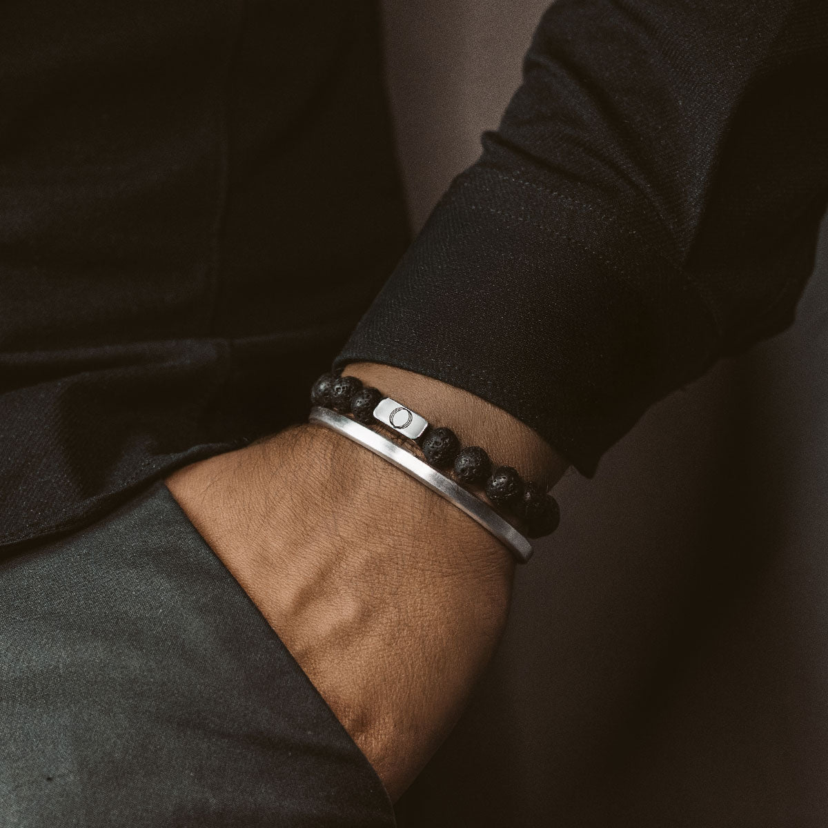 man wearing lava stone bracelet and silver bangle from Ninetwofive