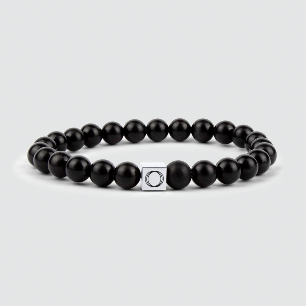 An Aswad - Matt Black Beaded Bracelet 8mm with an onyx stone and a silver clasp.