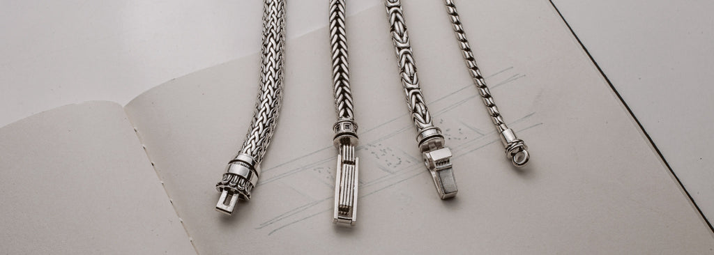 A group of silver chain links on a sheet of paper.