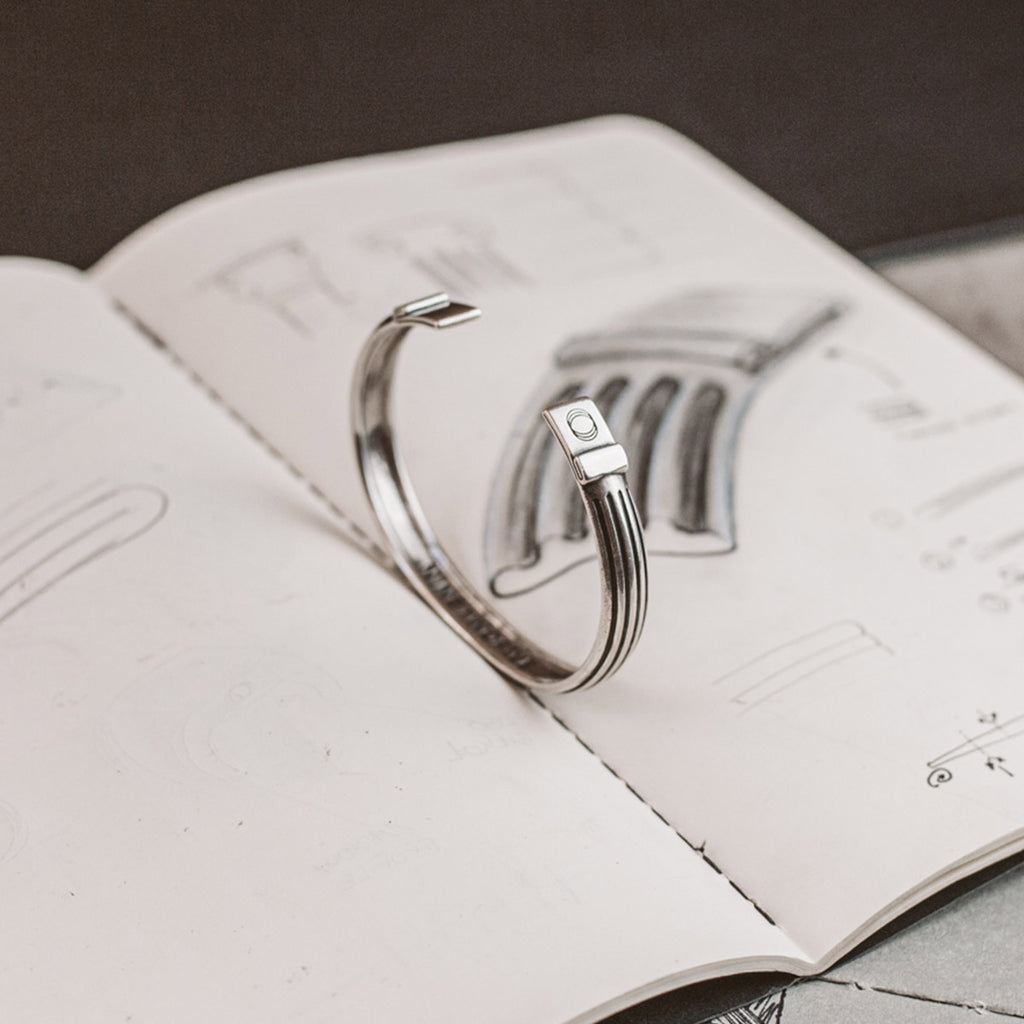 A drawing of a cuff ring on top of a notebook.
