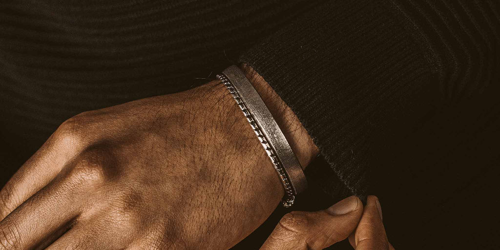 A man's wrist with a bracelet.