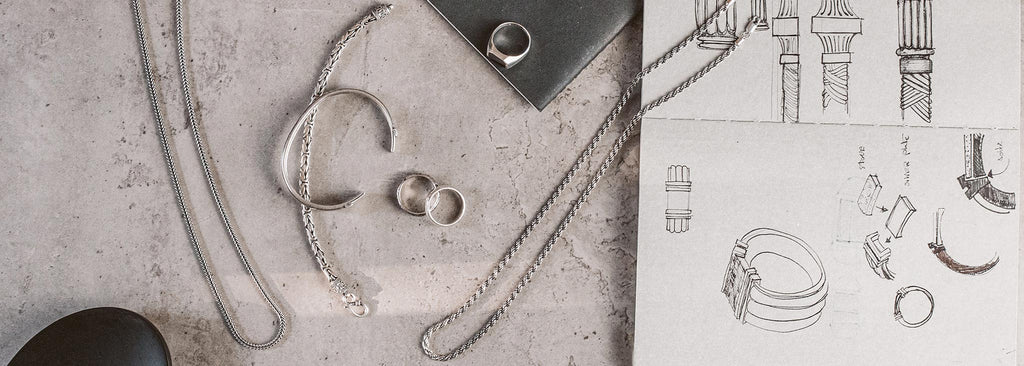 A collection of silver jewelry on a table.