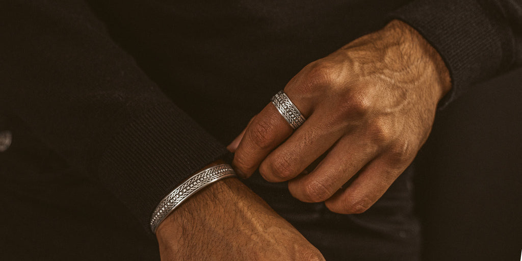A man wearing a personalised mens bracelet.
