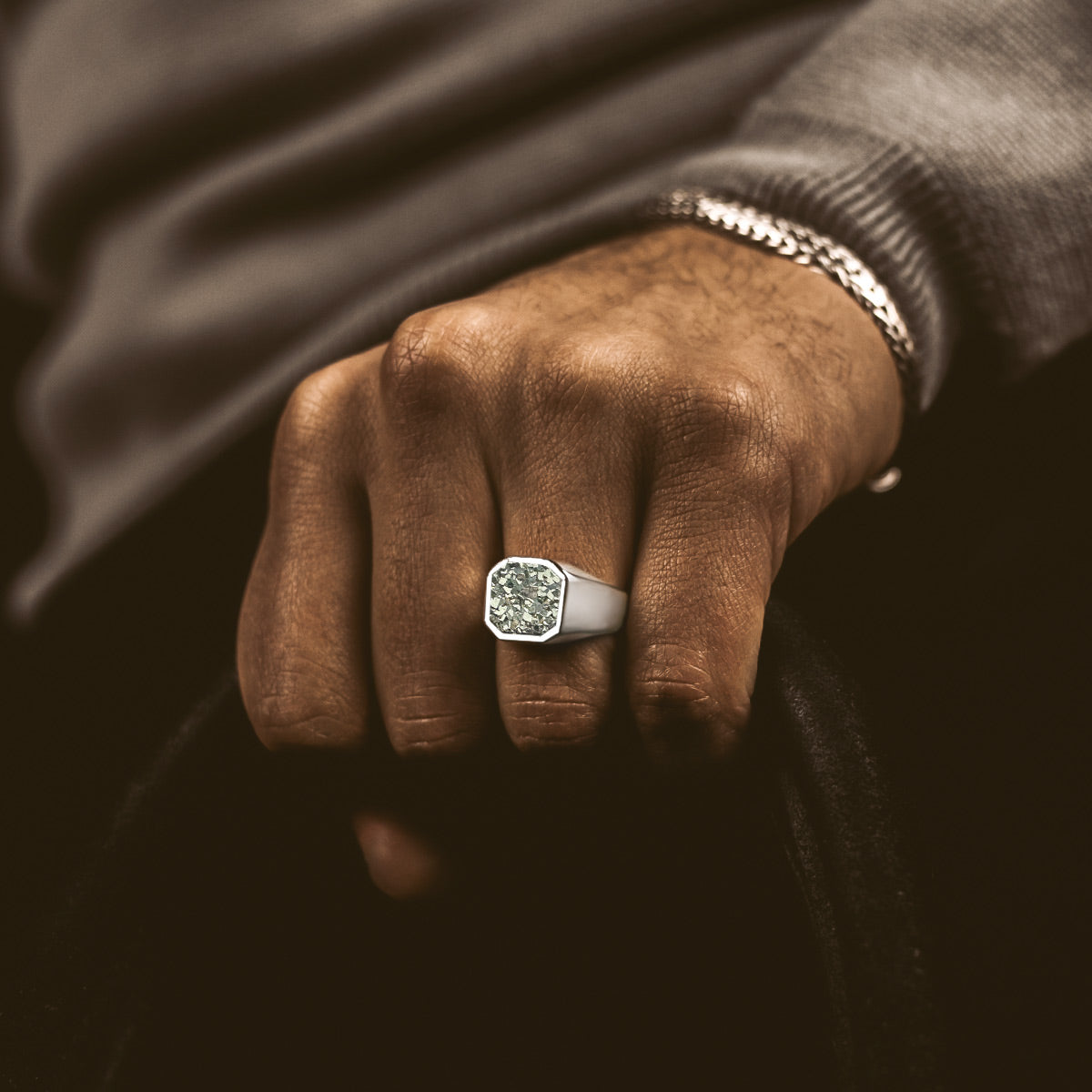 A model showing NineTwoFives signature mens silver signet ring from personalised jewellery collection. 