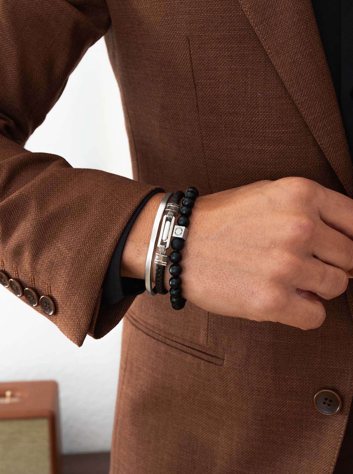 gentleman wearing silver jewellery and an onyx beaded bracelet