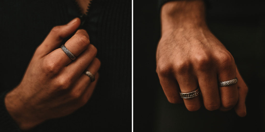 A person's hand with two rings on it.