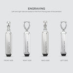 Silver pendant with text engraving on four sides on a light gray background