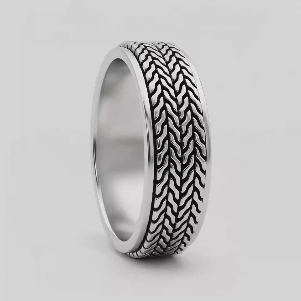 Hani sterling silver spinner ring turning, showing the herringbone pattern and polished edges