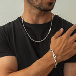 Model trägt qaws Silberkette und aqdas Herrenarmband von Ninetwofive