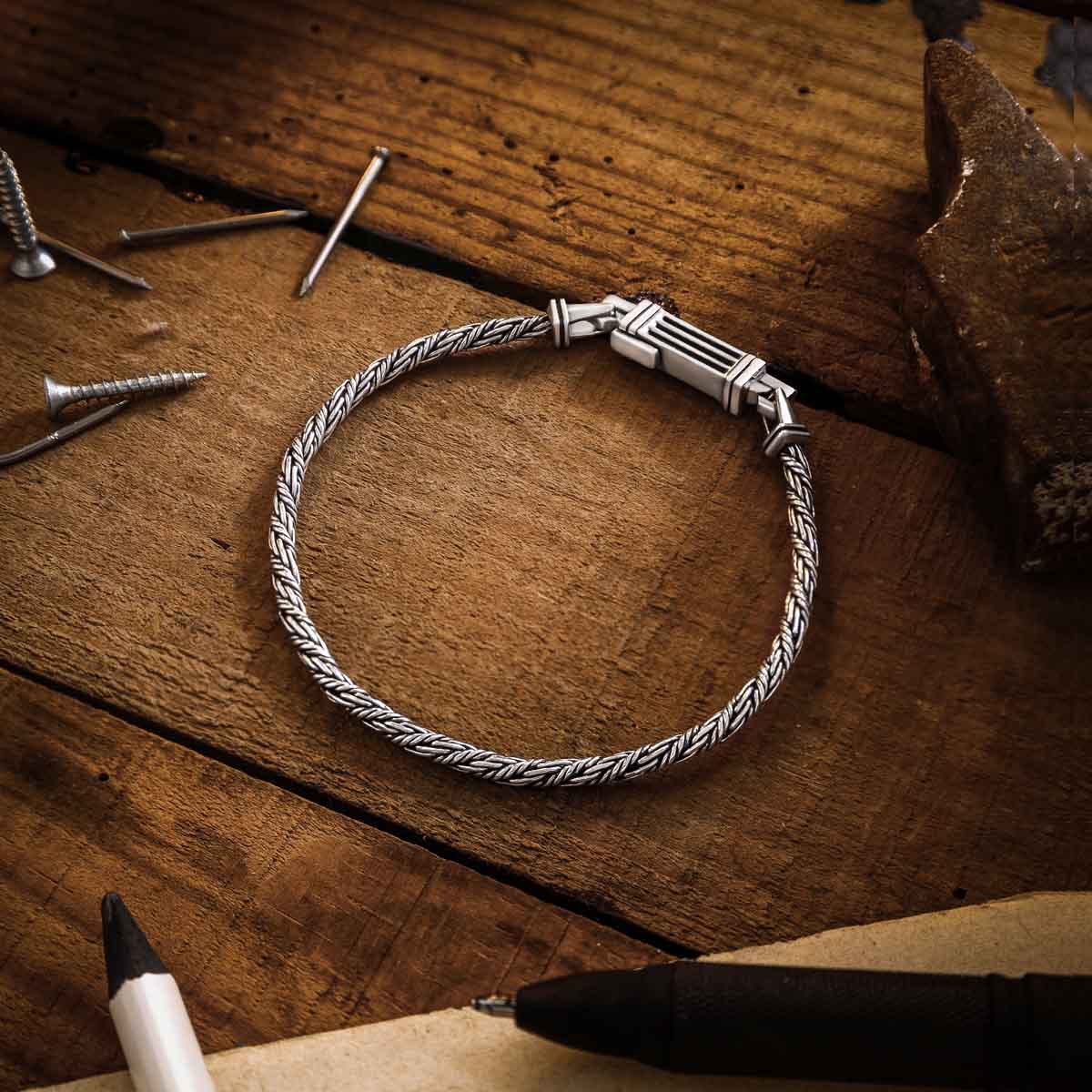 Nadir rope chain silver men’s bracelet from Ninetwofive on a wood