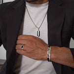 Man wearing samir sterling silver pendant, black onyx ring and leather bracelet from ninetwofive.