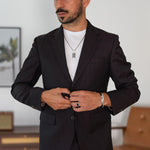 Model wearing samir sterling silver pendant, leather bracelet and black onyx ring from ninetwofive