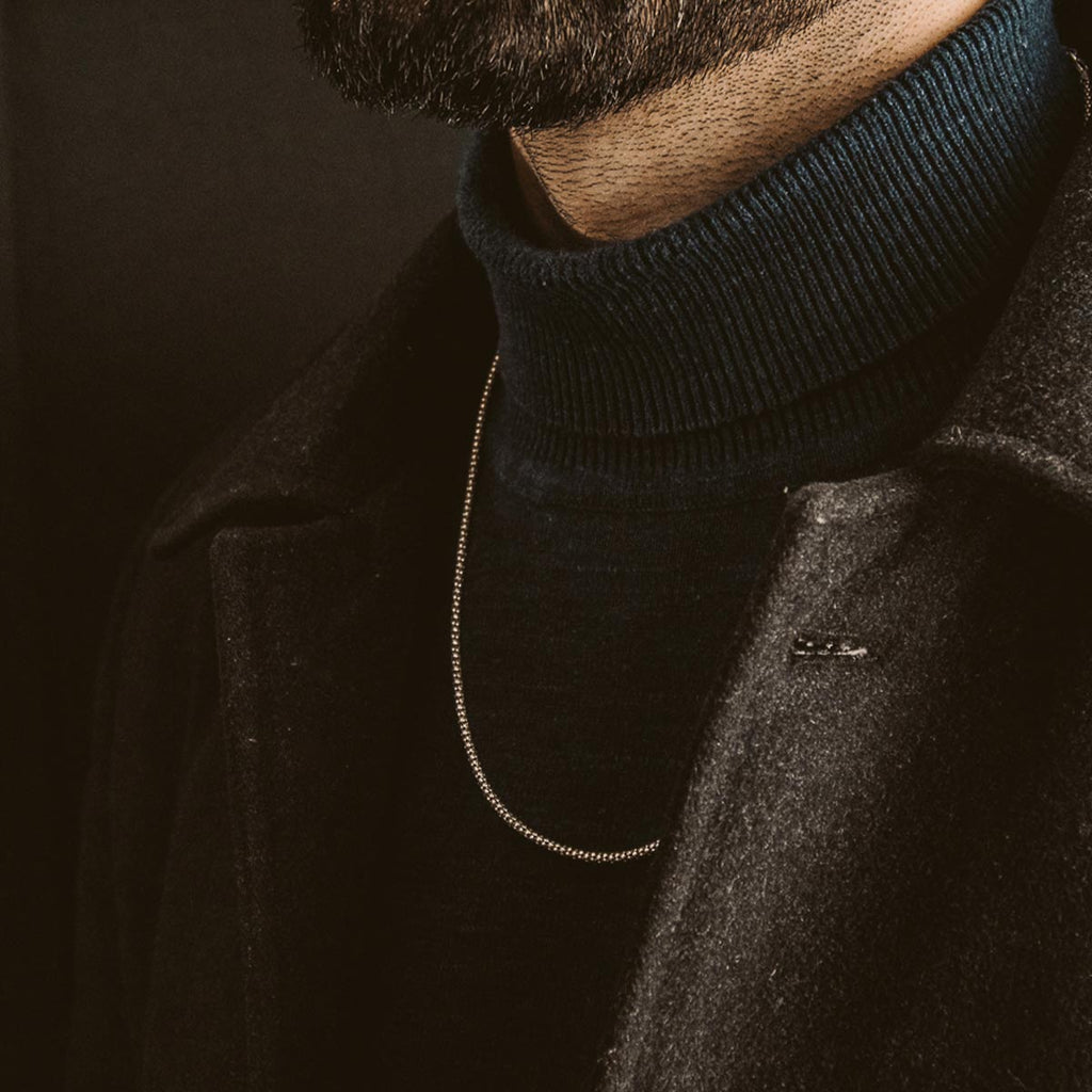 A bearded man wearing a turtleneck.
