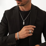 Model wearing Kaliq sterling silver pendant, bracelet and ring inspired by Berlin architecture. Ninetwofive