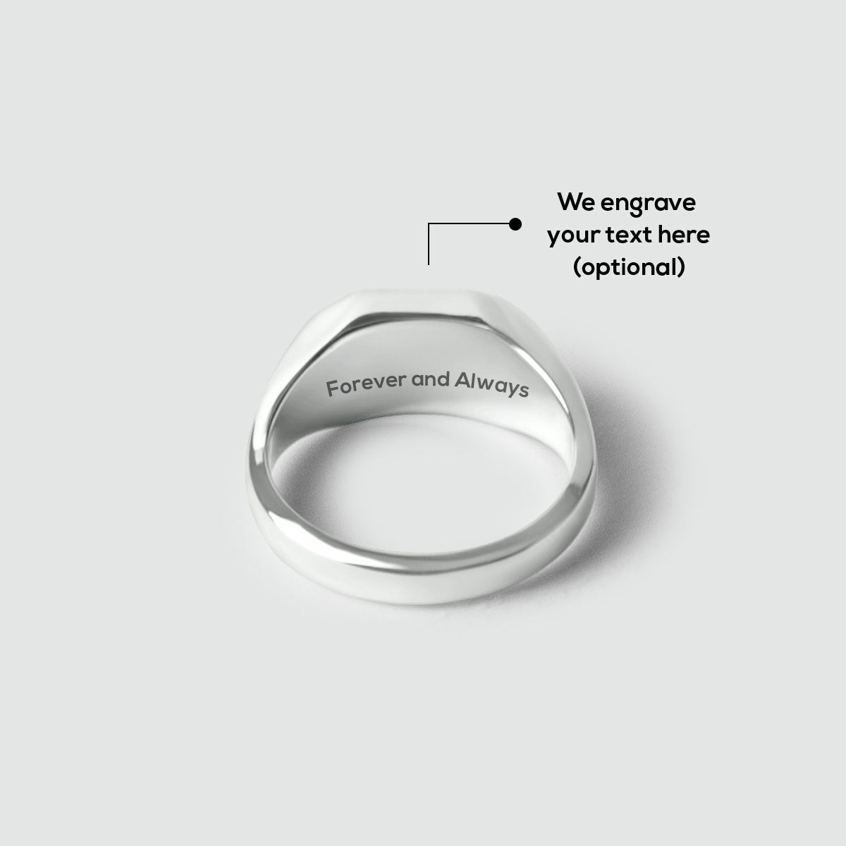 Mens silver signet ring with 'Forever and Always' engraving on a light gray background