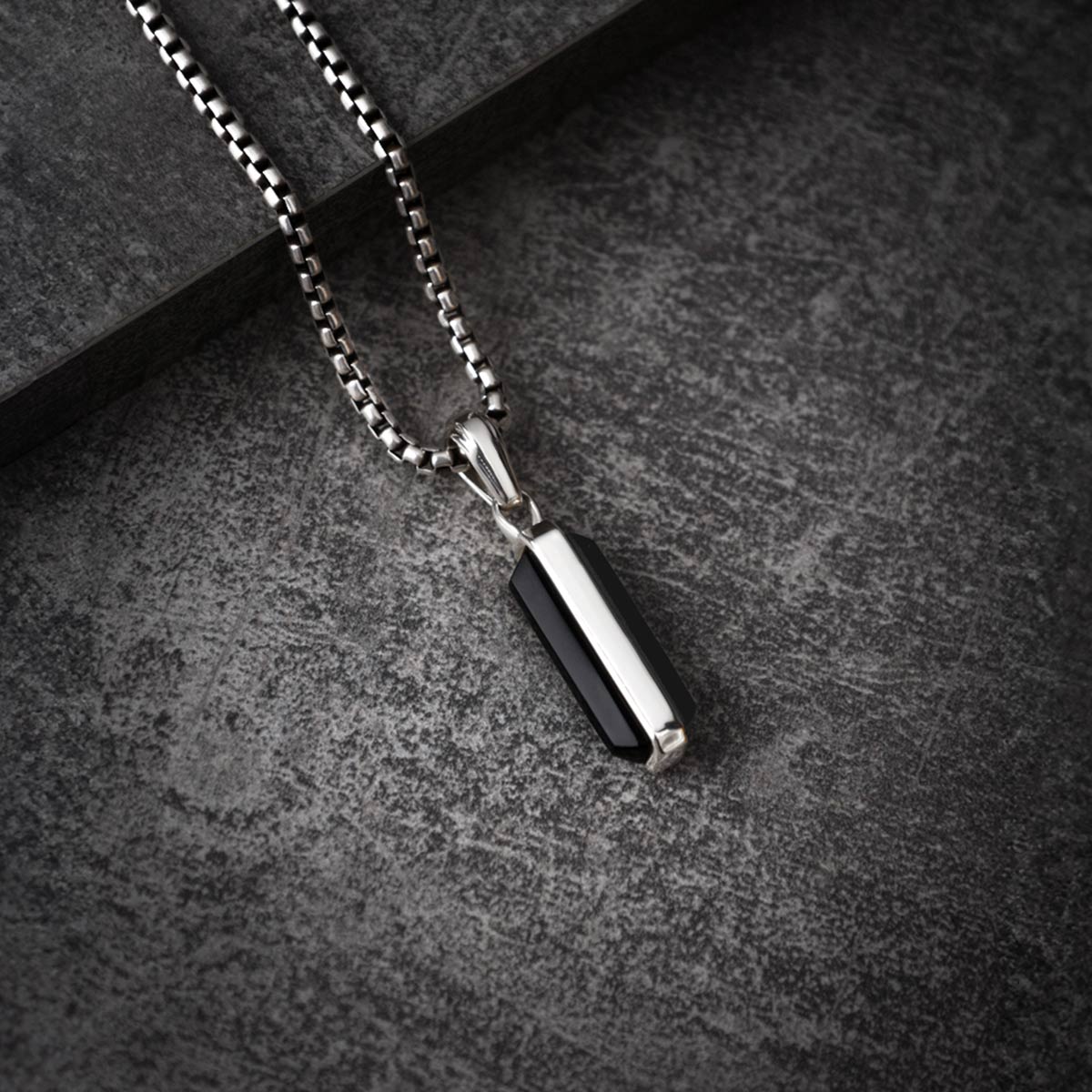 Samir sterling silver black onyx pendant for men on black paper from Ninetwofive