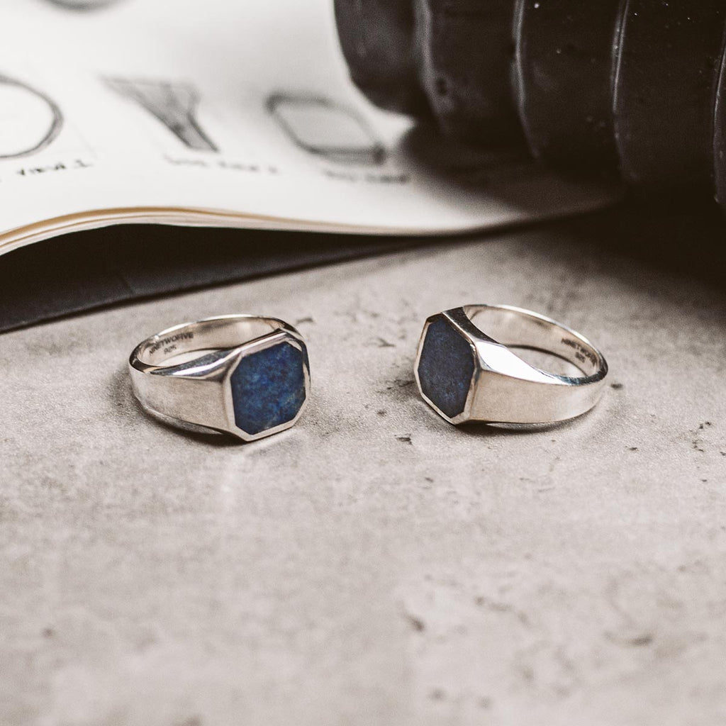 A pair of sterling silver ring with a blue stone.