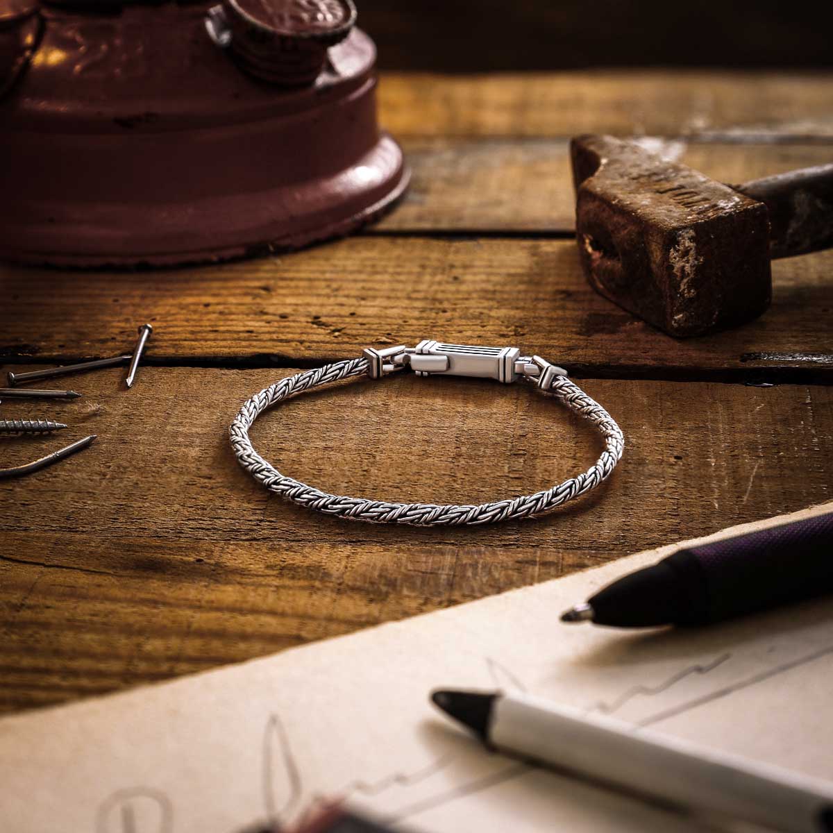 Nadir sterling silver rope chain men’s bracelet from Ninetwofive on a wood and pens background.