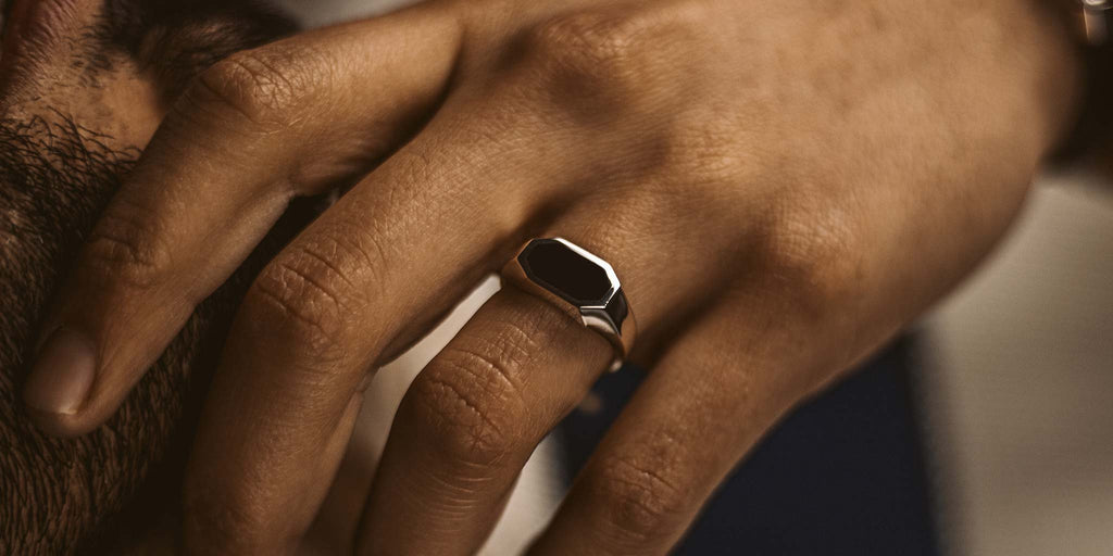 A person wearing a ring on his finger.