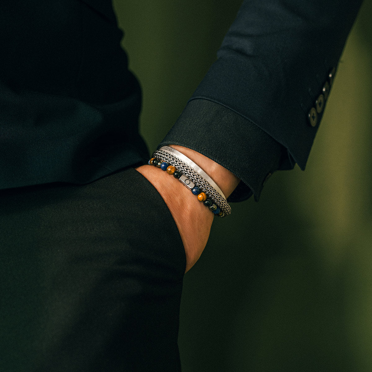 Lifestyle image of a man wearing a tiger eye bracelet