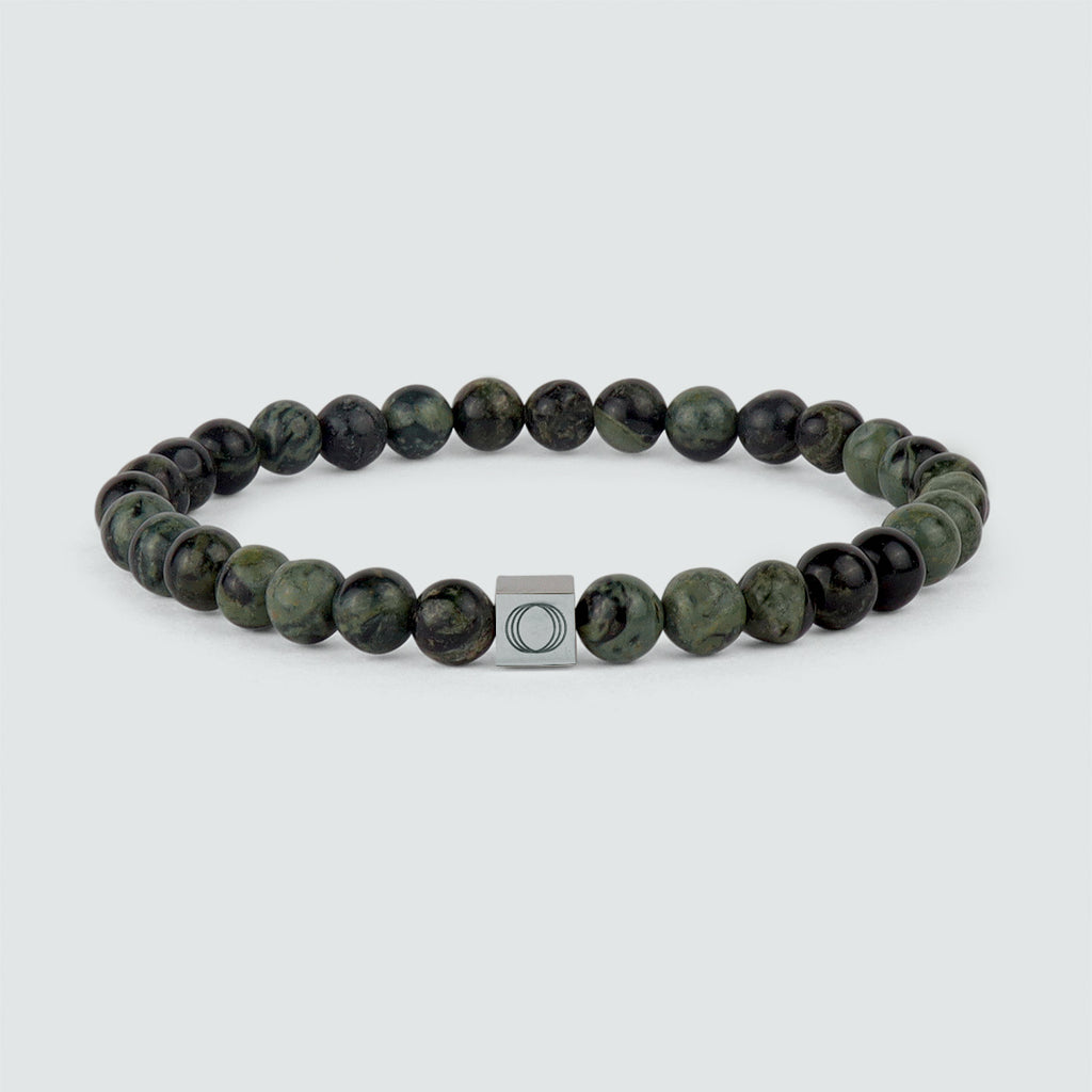 An Ahgdar - Green Beaded Bracelet 6mm with green jade beads and a silver clasp.