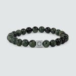 An Ahgdar - Green Beaded Bracelet 8mm with a green jade bead and a silver charm, featuring a weathering stone.