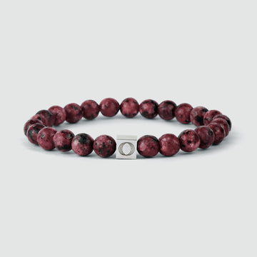 The Ahmar - Red Beaded Bracelet 8mm with red jasper beads and a silver clasp, known for its rich red color and durability.