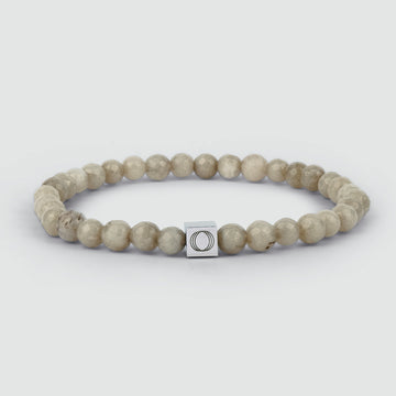 A Albij - Beige Beaded Bracelet 6mm with a silver square charm, carved out of jade stone.