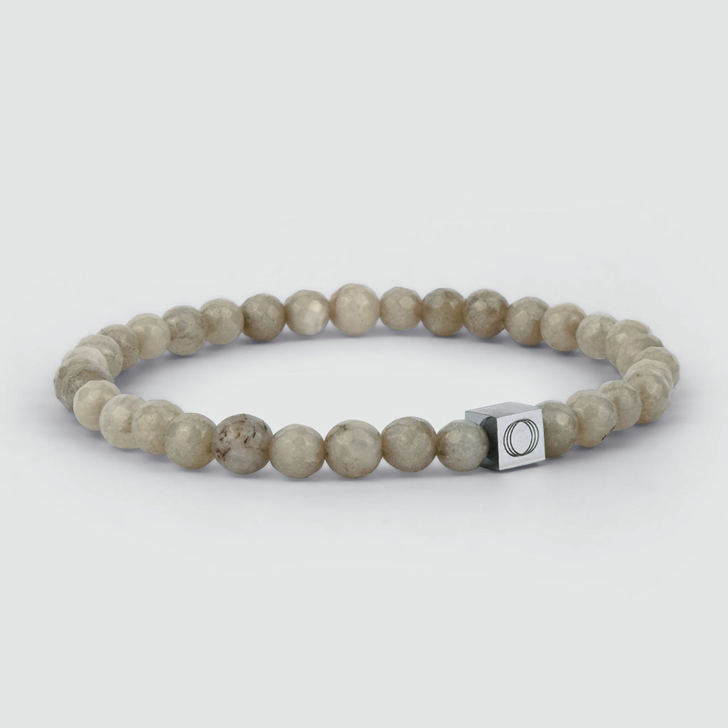 A grey stone bracelet with a silver clasp, carved out of Albij - Beige Beaded Bracelet 6mm.