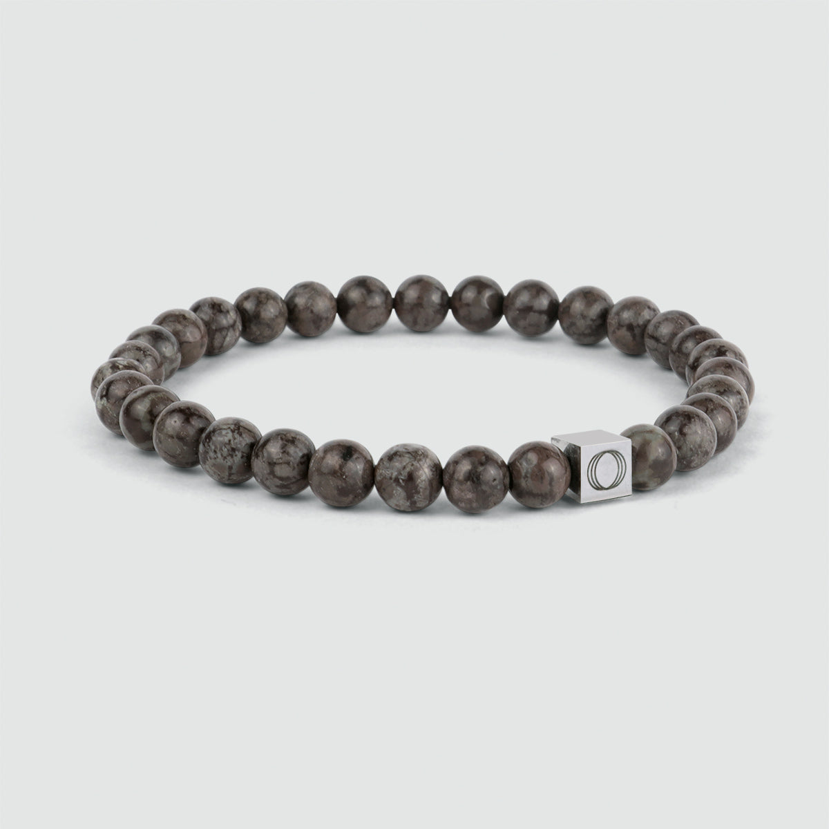 An Albuna - Brown Beaded Bracelet 6mm with a snowflake stone bead and a silver charm.
