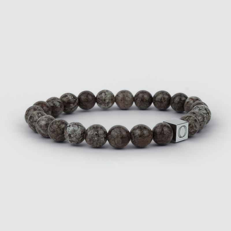 Side angle of the Albuna mens brown beaded bracelet, showing the beads and the visible Ninetwofive logo detail.