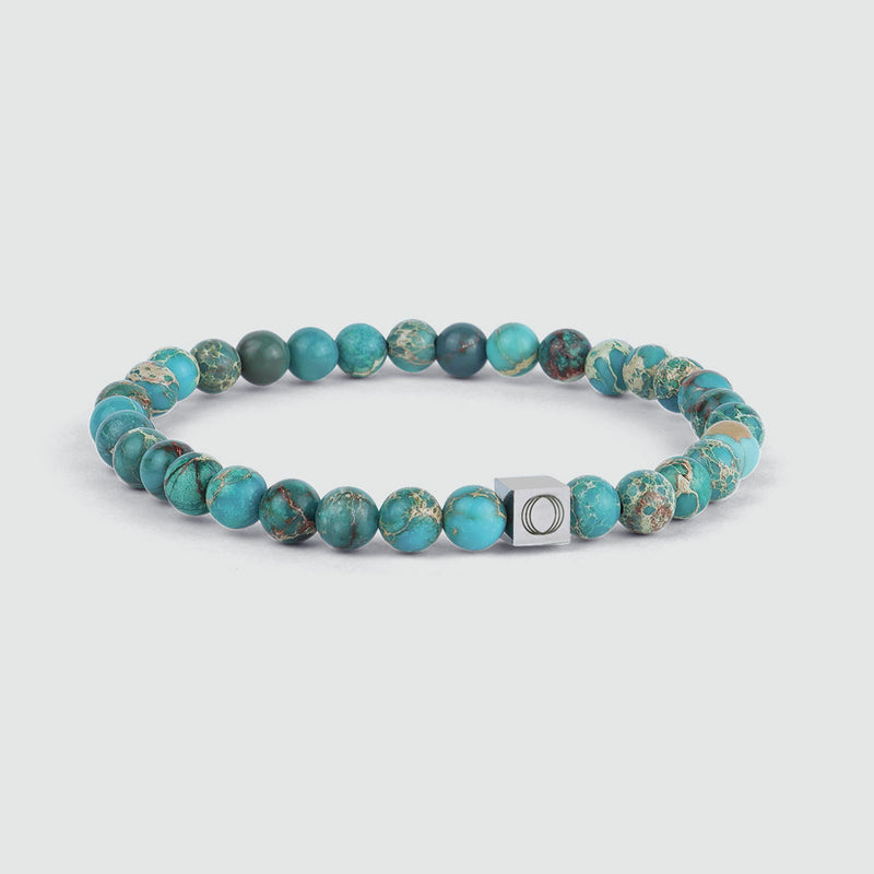 Een zijaanzicht van de Alfiruz turkooizen heren armband, waarop de kralen en het gegraveerde Ninetwofive-logo te zien zijn.