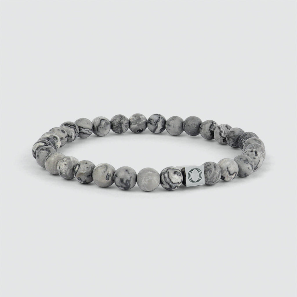 An Alrazas - Grey Beaded Bracelet 6mm with a grey marble bead and a silver clasp.