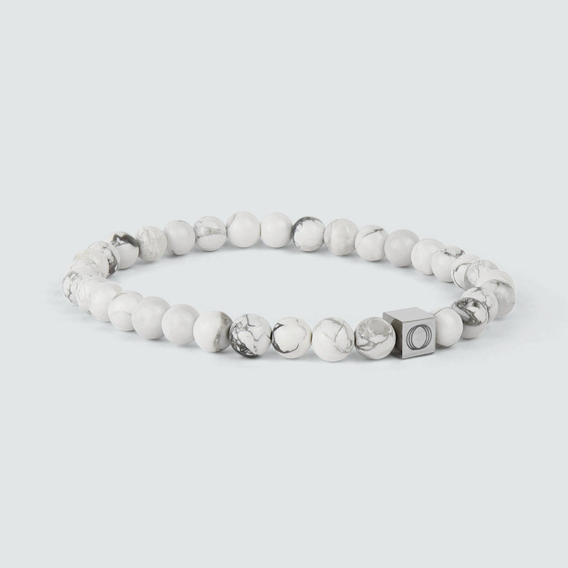 Side angle of the Alrukham mens white beaded bracelet, showing the detailed look of the beads and the Ninetwofive logo detail.