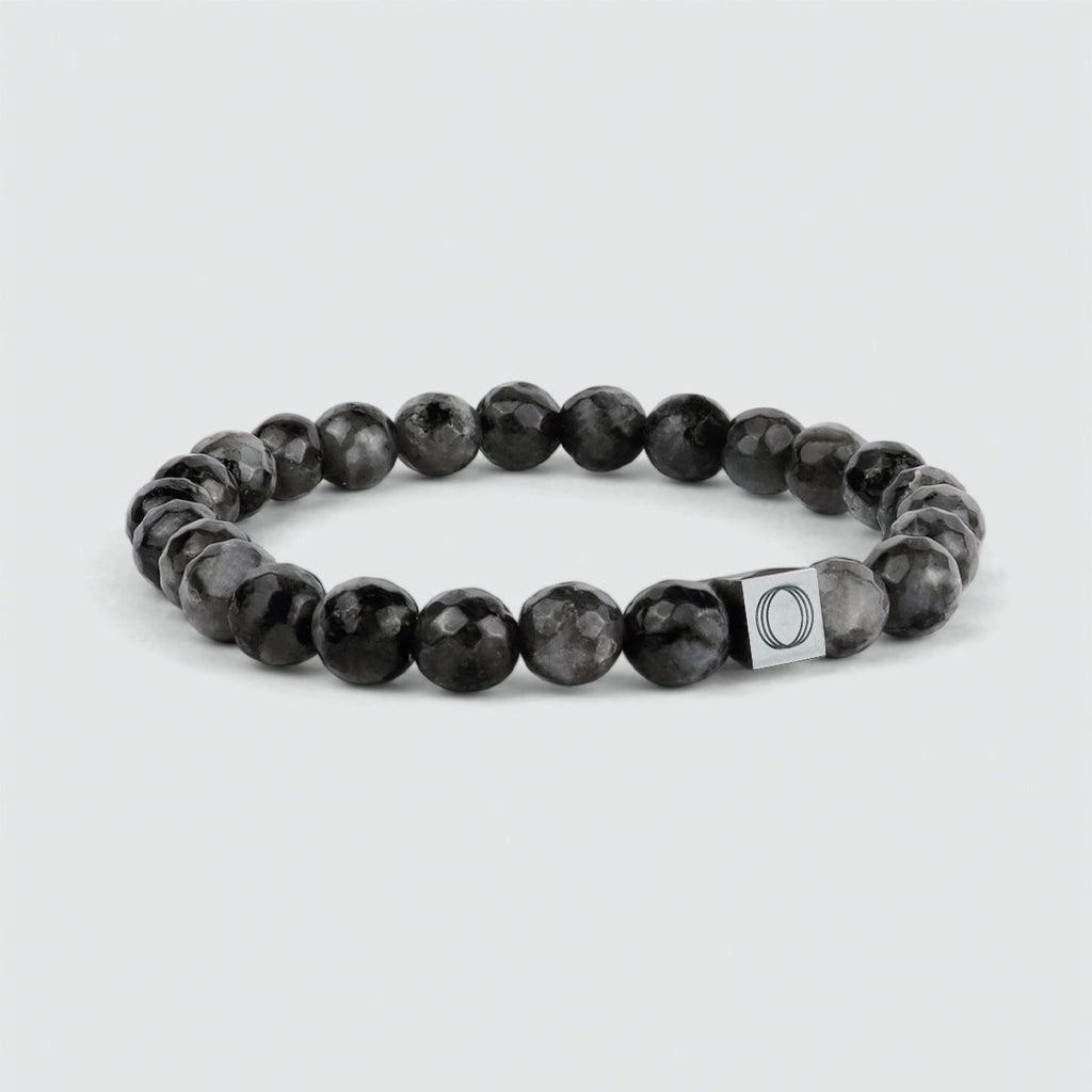 The Aswad - Black Beaded Bracelet 6mm, with the letter o on it, showcases a spectrolite stone.