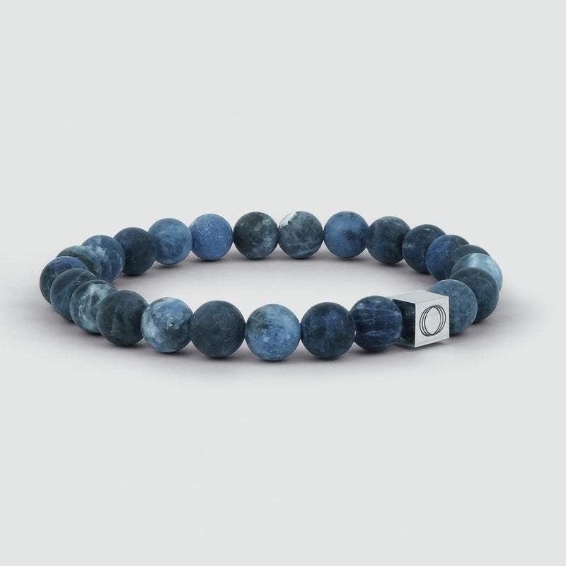 Close-up of the Azraq sodalite stone blue beaded mens bracelet, showing the Ninetwofive logo engraved.