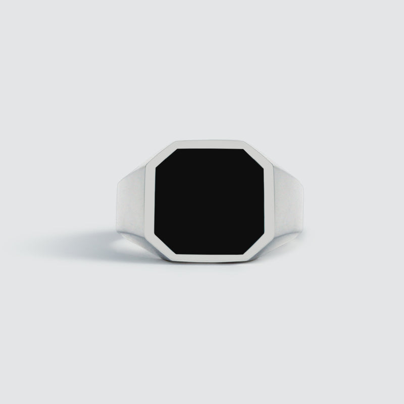 Close up view of Naim black onyx mens signet ring on a white background by Ninetwofive. 