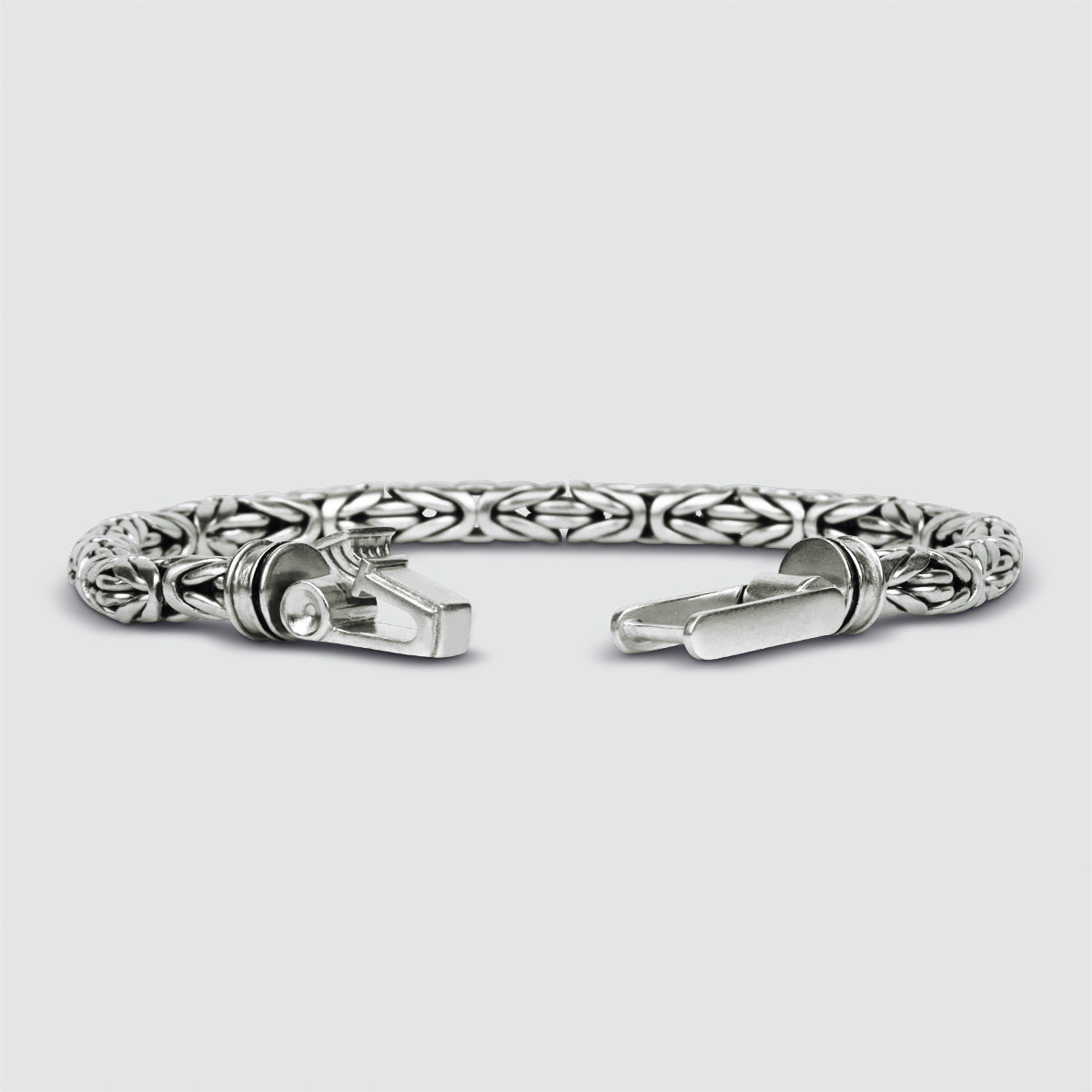 A intricately engraved NineTwoFive silver bracelet, personalized for men.