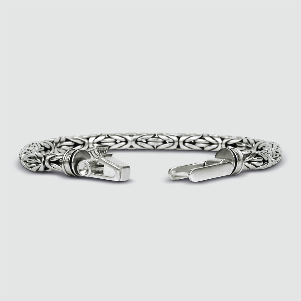 A intricately engraved NineTwoFive silver bracelet, personalized for men.