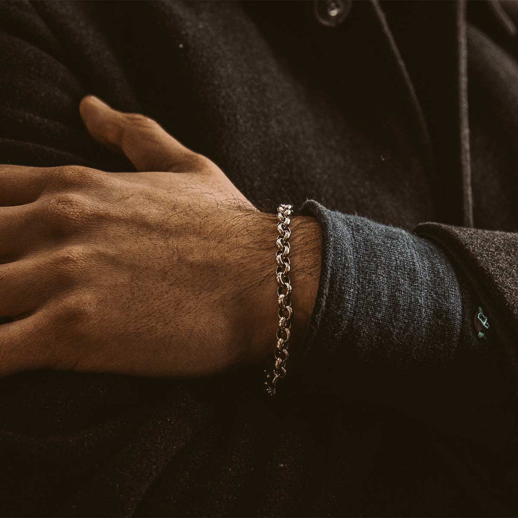 A man donning a NineTwoFive - Ishak Sterling Silver Chain Link Bracelet 6mm on his wrist.