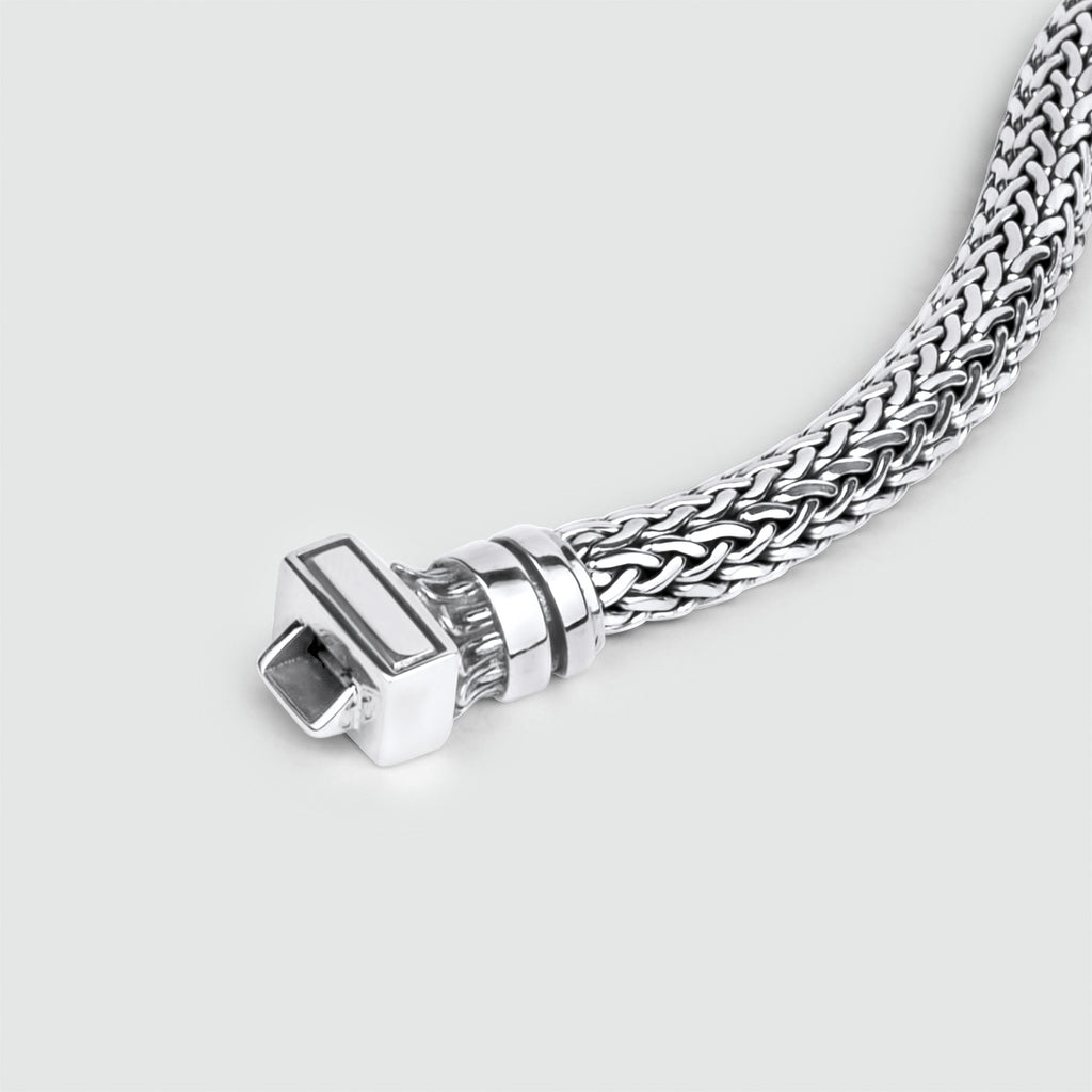 A stylish NineTwoFive Mirza - Sterling Silver Braided Bracelet 7mm on a white background.