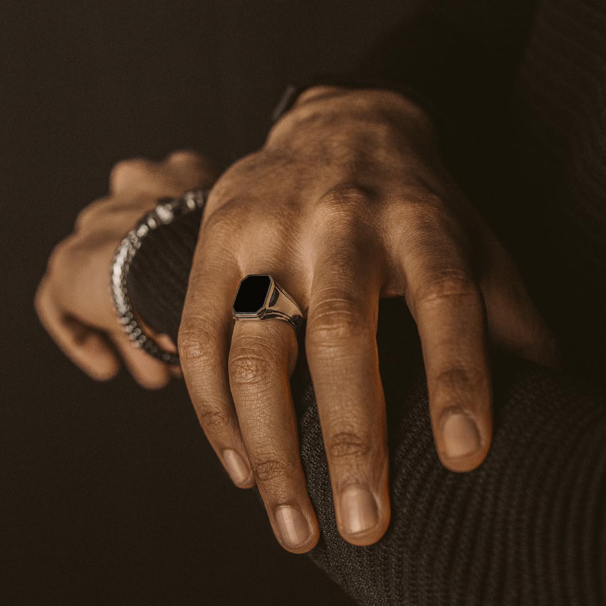 A man wearing a NineTwoFive Baki - Black Onyx Signet Ring 17mm.