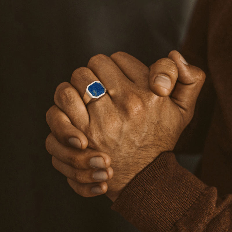 Man in a brown cozy sweater shows off the Kadar sterling silver mens ring, Ninetwofive.
