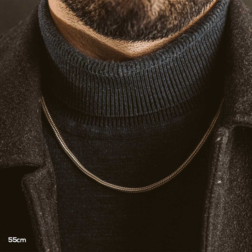 A close up of a handmade bearded man wearing an Anis - Sterling Silver Wheat Chain Necklace 3mm.